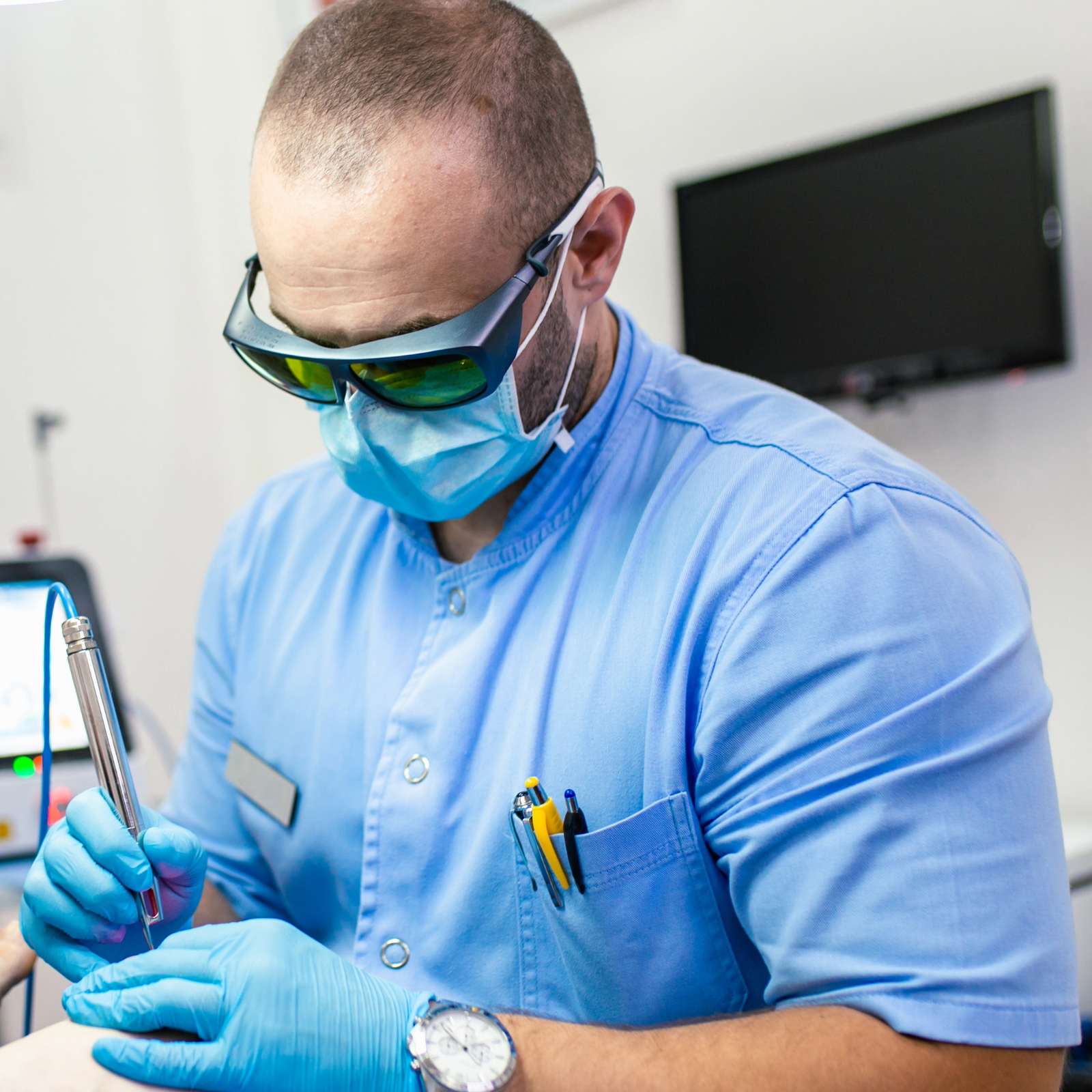 male podiatrist doing surgery