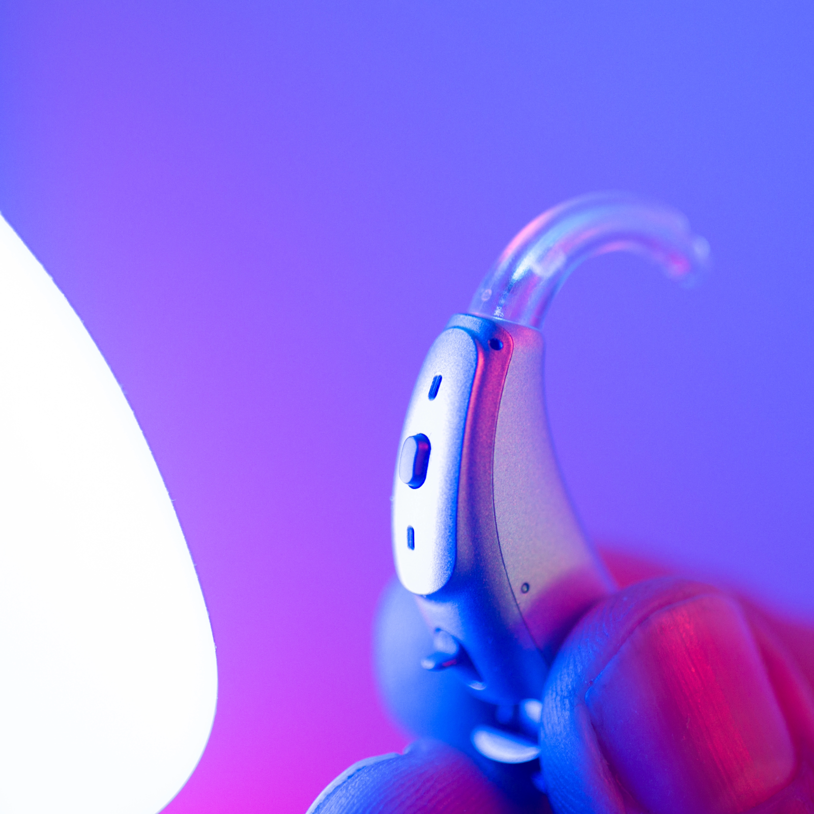 audiologist holding up a high tech hearing aid