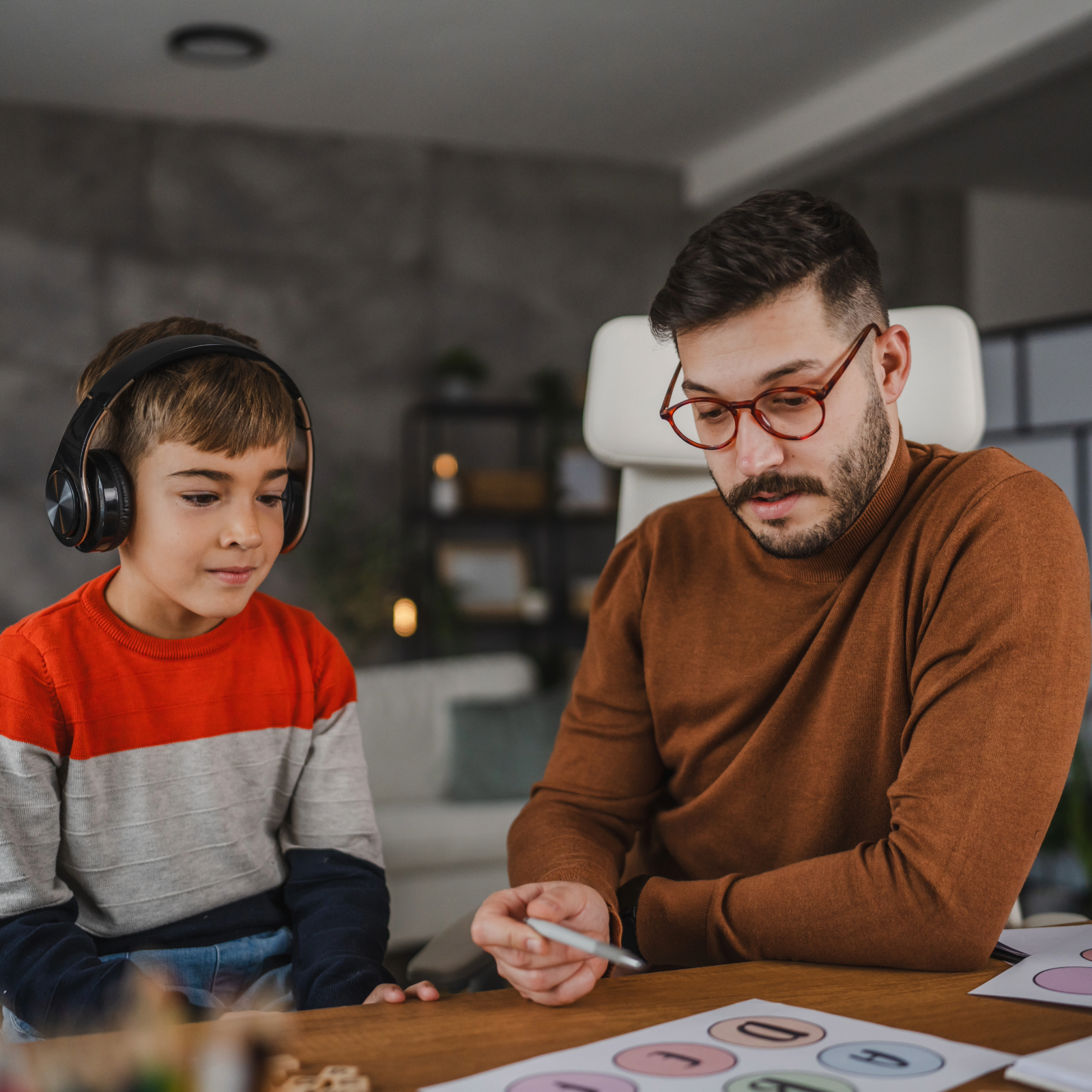 Male speech and language therapist with child patient 